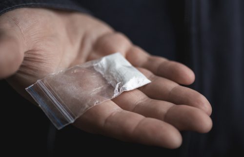 man holding cocaine