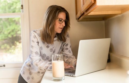 woman working from her computer while doing suboxone detox at home