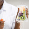 nurse holding iv bag with fruits; to discuss article on iv vitamin therapy benefits