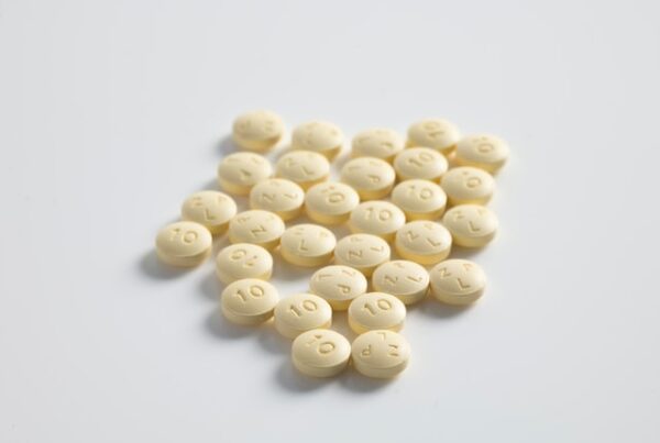 yellowish colored pills on white background