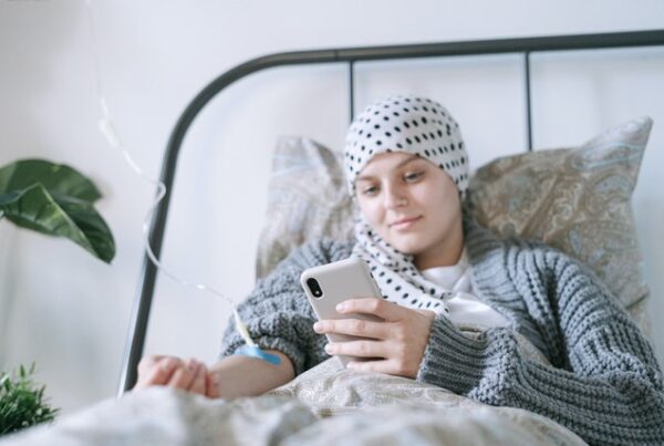 young woman on phone receiving IV at home