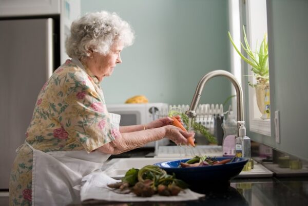 independent elderly woman preparing food at home