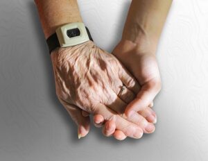 young hand holding elderly hand - senior home companions los angeles